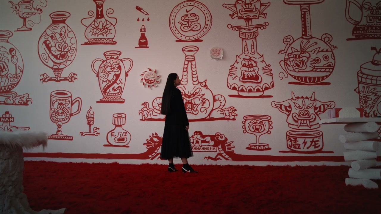 A red mural scene with a lens color cast applied, the hue shifting across the frame from center to edges